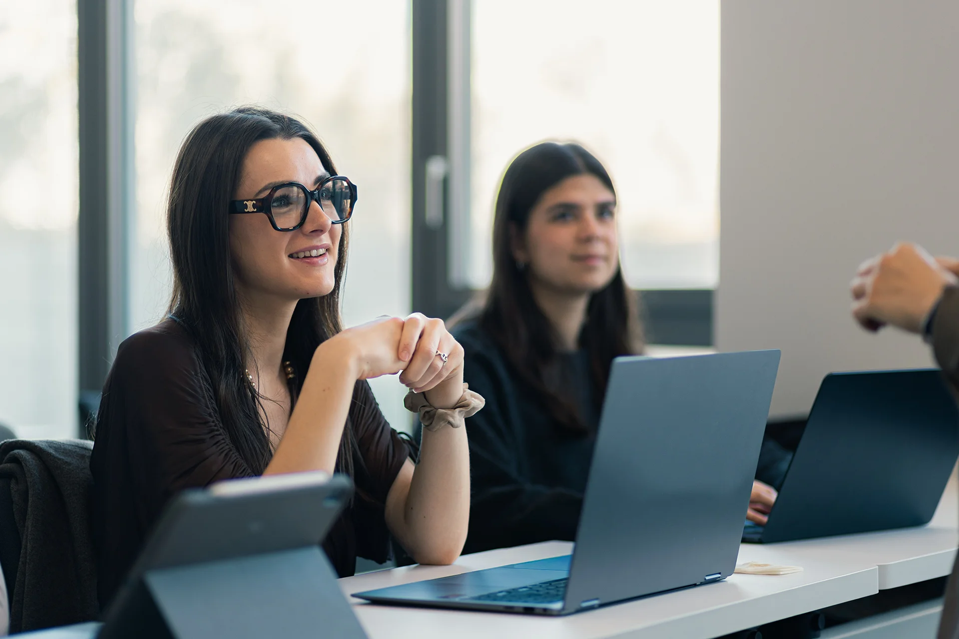 Students in a classroom working on laptops during an academic program