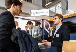 Networking event booth at emlyon business school with participants discussing with exhibitors