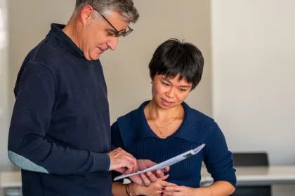 Un enseignant en train de consulter les notes d’une étudiante.