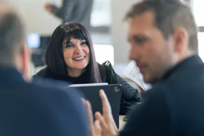 Team discussion during a collaborative meeting in a modern office environment.