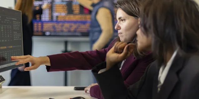 Two people at the office looking at a computer screen.