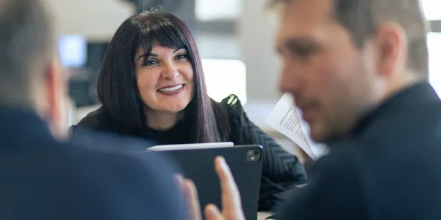 Team discussion during a collaborative meeting in a modern office environment.