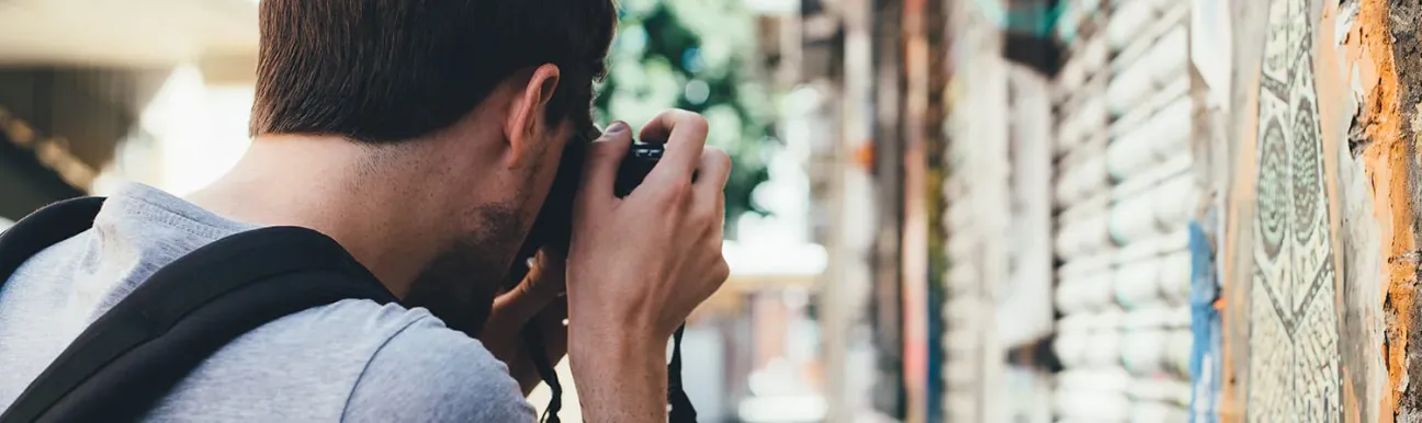 A man with a camera, taking some street pictures