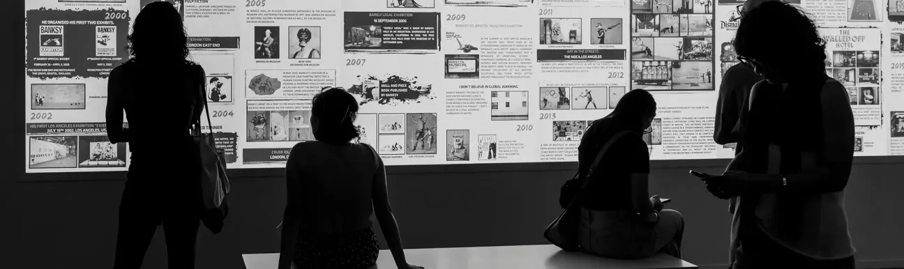 Visitors exploring an interactive timeline showcasing the impact, achievements, and innovation initiatives of a research center.