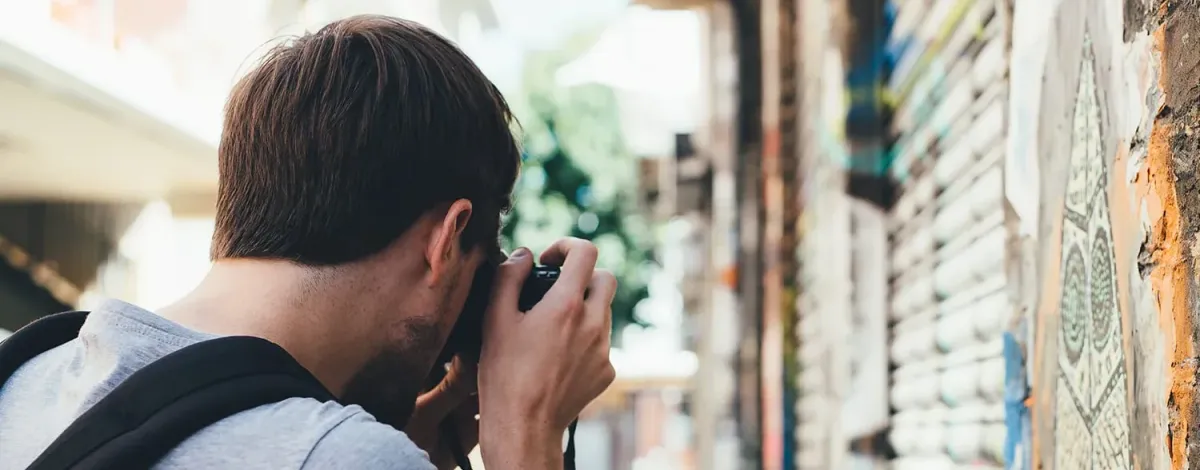 A man with a camera, taking some street pictures