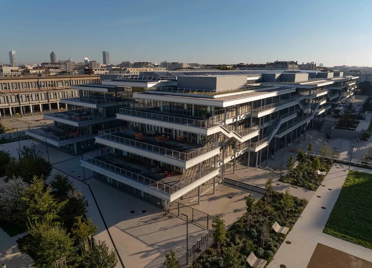 Aerial perspective of the emlyon business school campus showing modern architecture and surrounding city