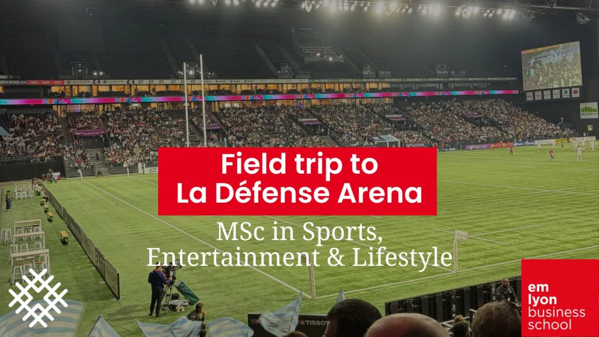 Indoor stadium view at La Défense Arena with a full audience during a sports event, featuring the illuminated field and emlyon business school’s MSc in Sports, Entertainment & Lifestyle program promotion.