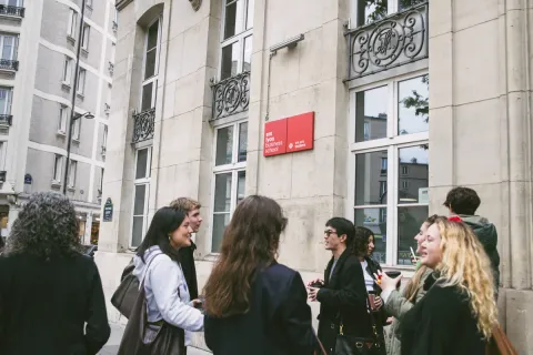 Des étudiantes et étudiants d'emlyon business school devant le campus de Paris
