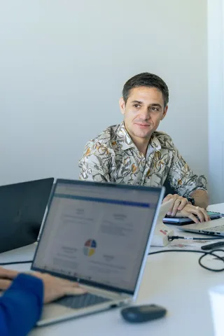 Professional working session with laptops and documents in a bright meeting room