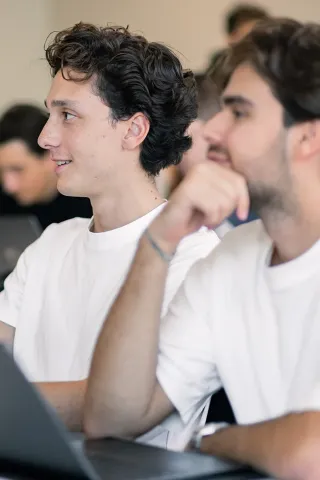 Session de formation avec un groupe d’étudiants attentifs face à une intervenante.