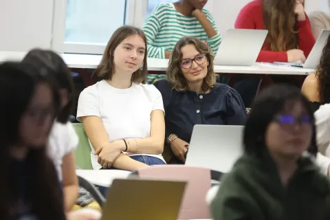 Students in a classroom working on laptops during an academic program.