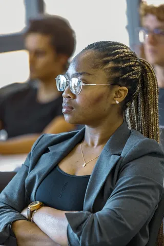 Student from the emlyon MSc in Finance attending a class, focused on an academic lecture in a classroom setting.