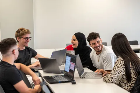 Group work using laptops in a classroom 