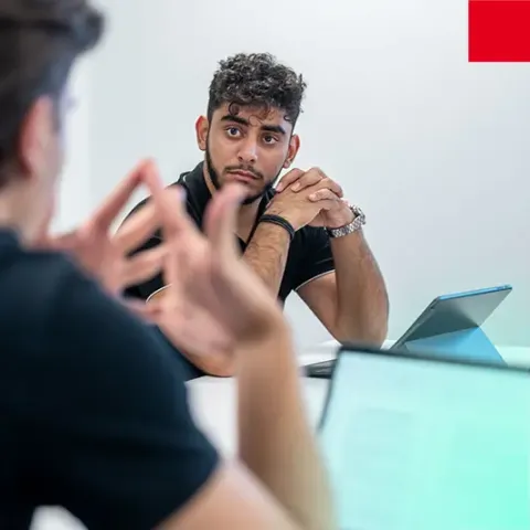 Student participating in a classroom discussion at emlyon tech school, collaborating with peers during an interactive learning session.