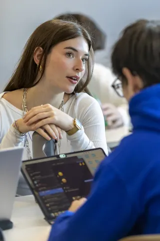 Students collaborating on digital and technology projects within an innovative higher education learning environment.